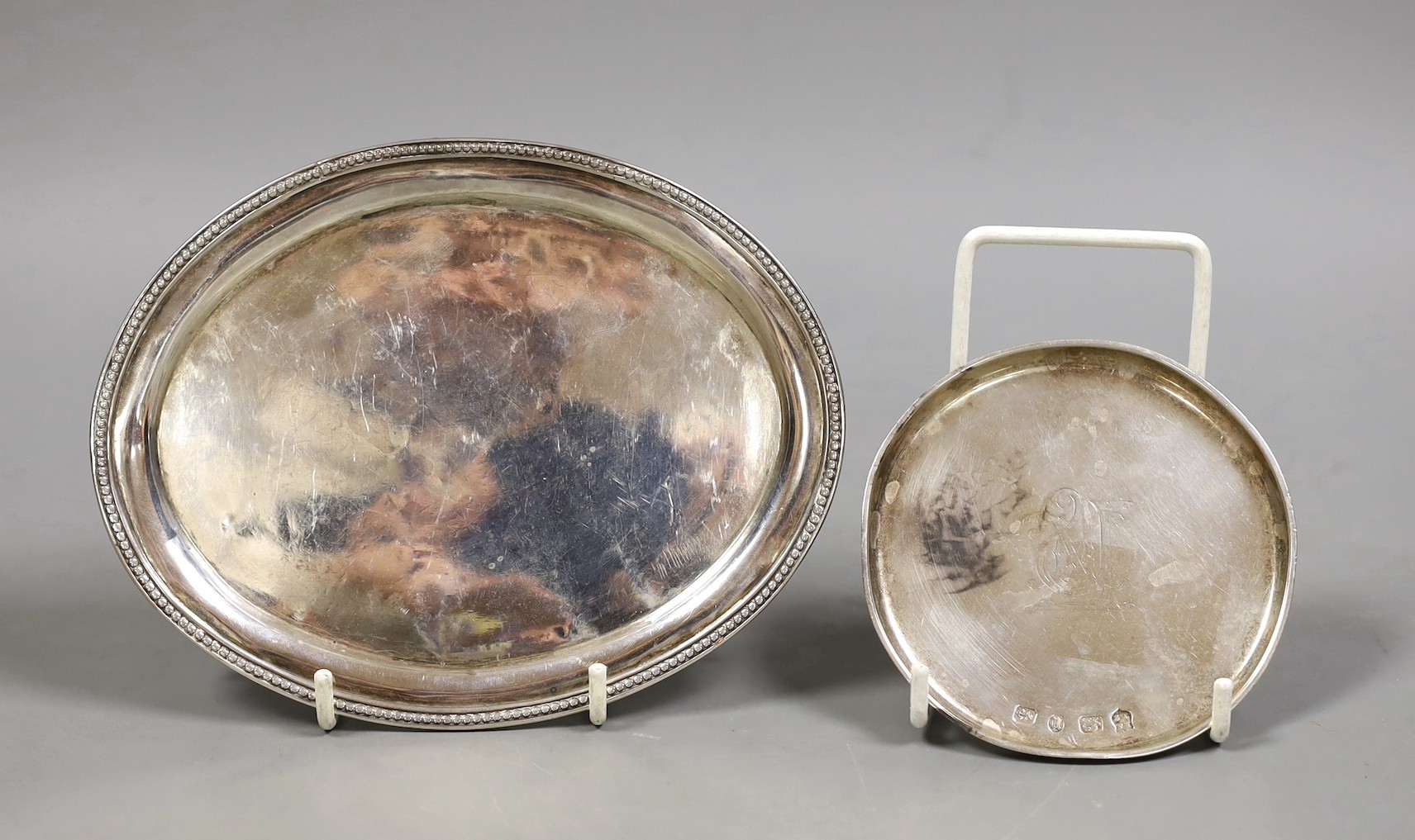 A George III silver oval teapot stand, TW, London, 1808, 16cm and a late Victorian small silver shallow dish, 5.2oz.